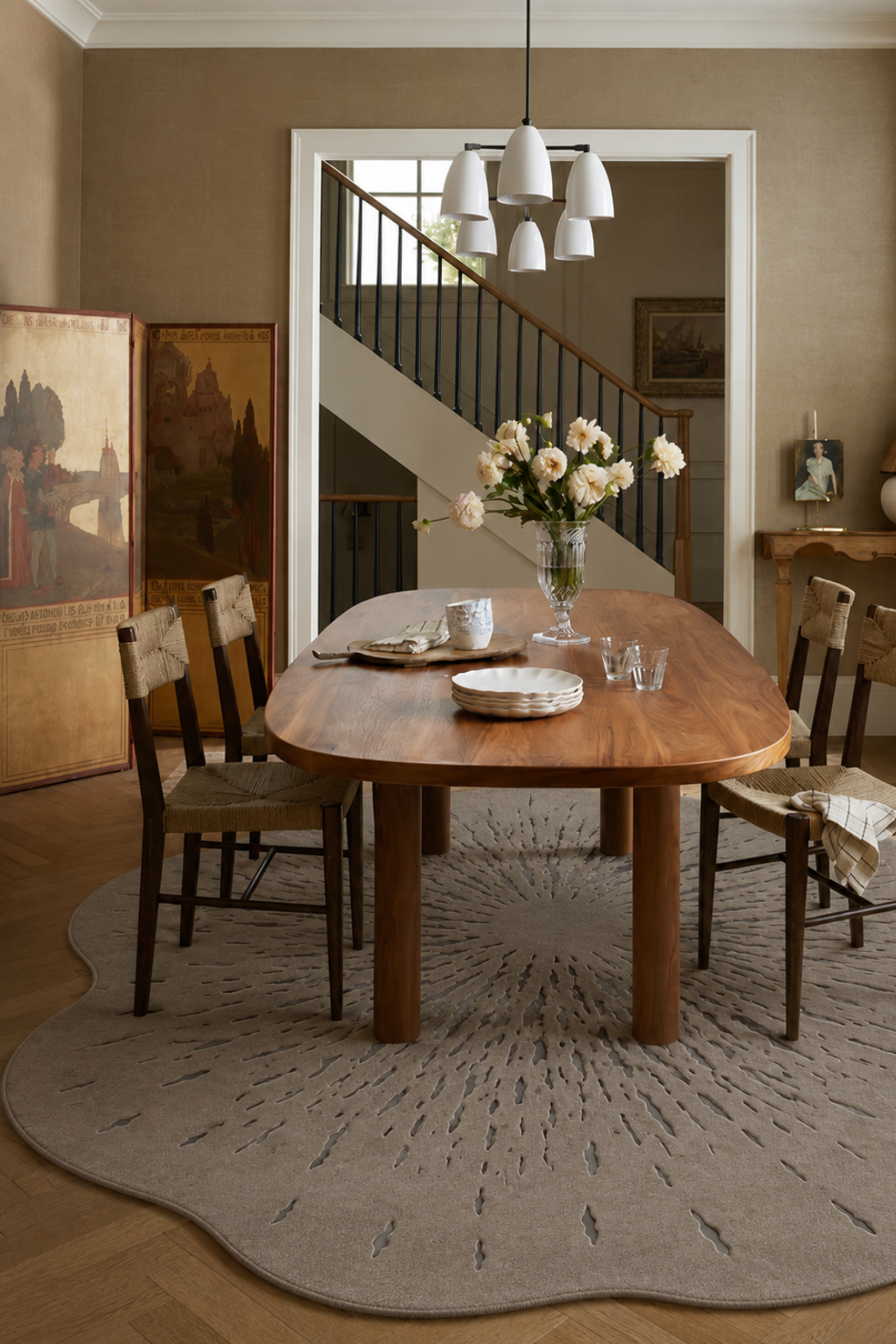 Luxury floral hand-tufted rug under a wooden dining table, enhancing a modern interior decor.