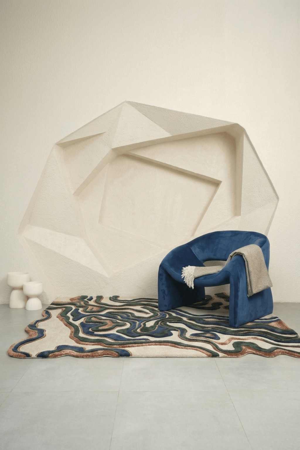 Interior setting featuring the Terra Wave Contour Rug with a blue chair, highlighting organic design and earthy tones.