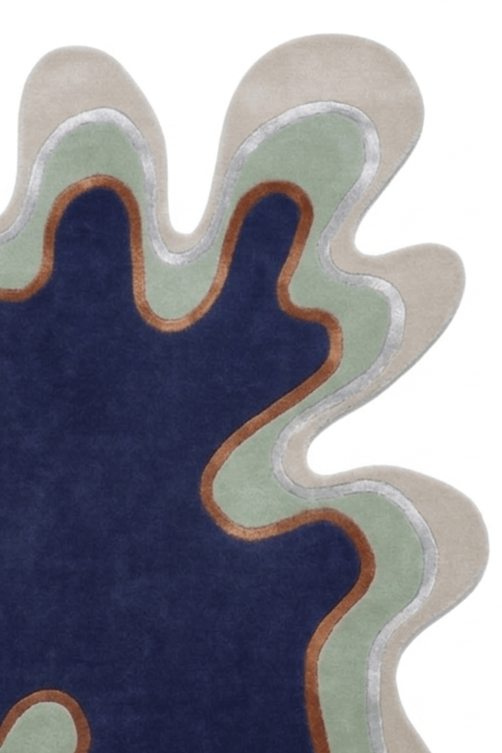 Irregular hand-tufted rug featuring a bold, organic design with a sculptural silhouette in various colors.