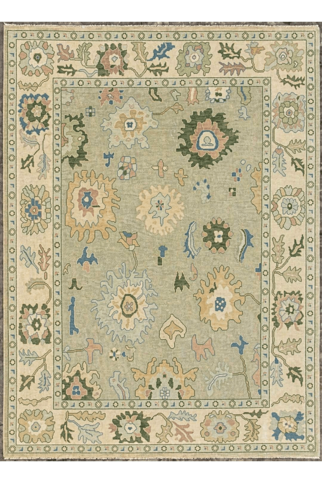 Heritage Meadow Hand-Knotted Rug featuring intricate floral and geometric motifs in a sage-green field.