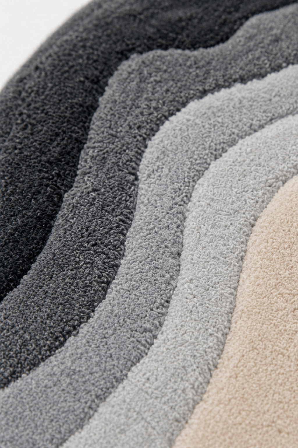 close-up view of the organic contour rug showcasing layered textures and colors in fluid, topographic designs