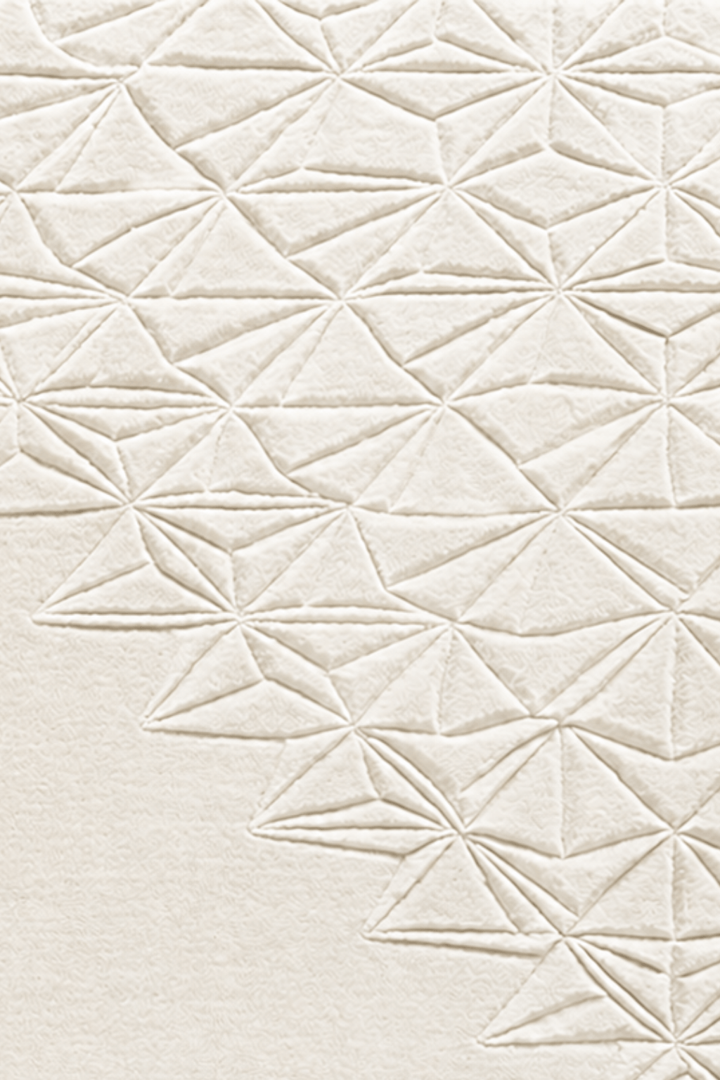 Ivory geometric wool rug with intricate faceted star-like geometric motifs in a high-low textured design.