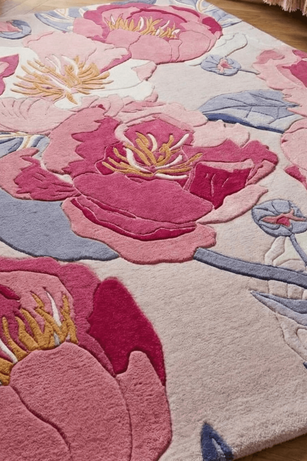 Roselle bloom hand-tufted rug featuring oversized floral motifs in rich pink and blue tones.