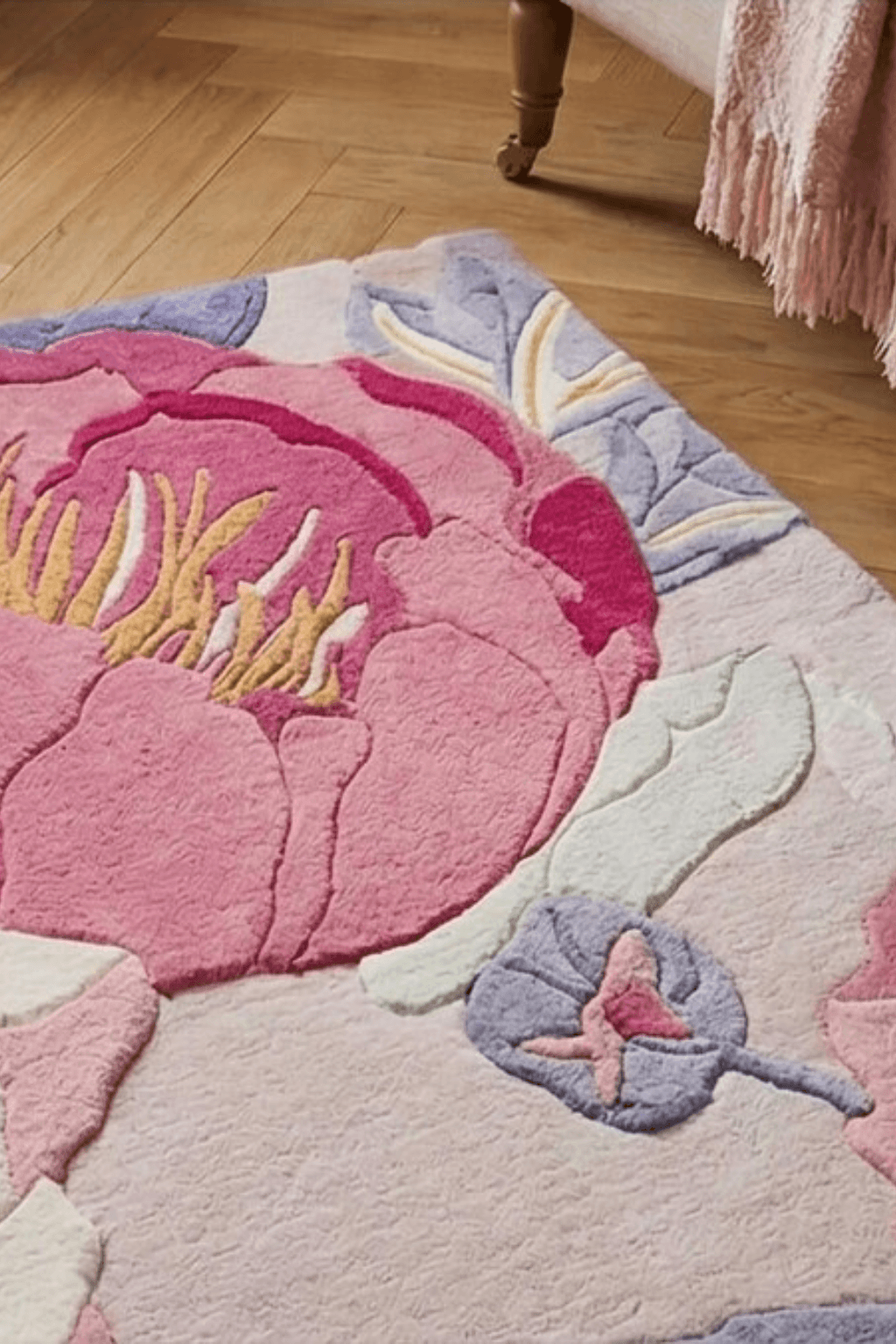 Roselle bloom hand-tufted rug featuring oversized floral motifs in rich rose pink, blush, ivory, and soft blue tones.