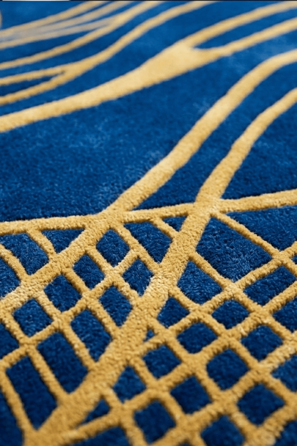 Close-up of the azure gilded wave sculptural rug showcasing its deep navy texture and golden designs.