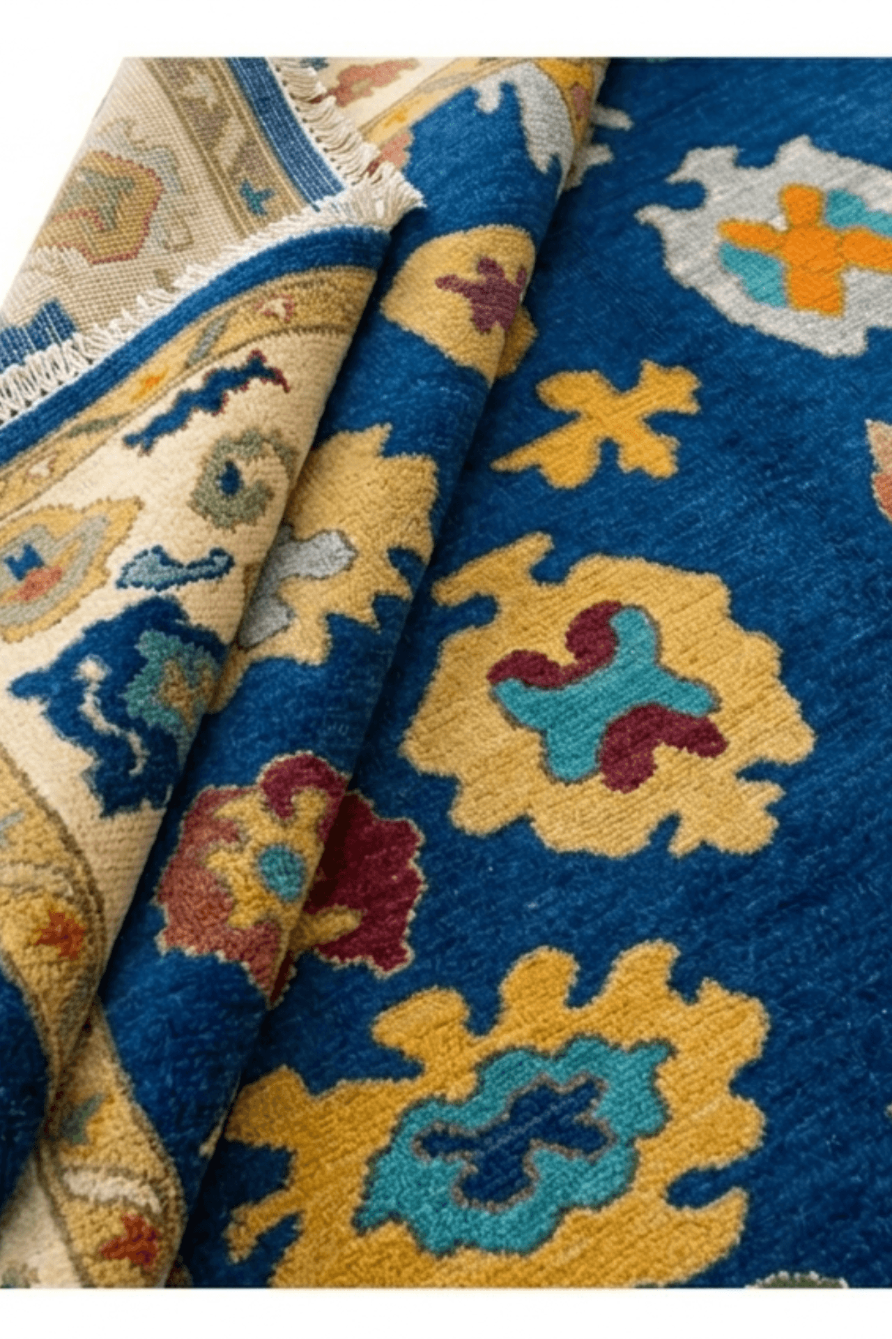 Deep blue hand-knotted wool rug featuring intricate artisan motifs in vibrant colors.