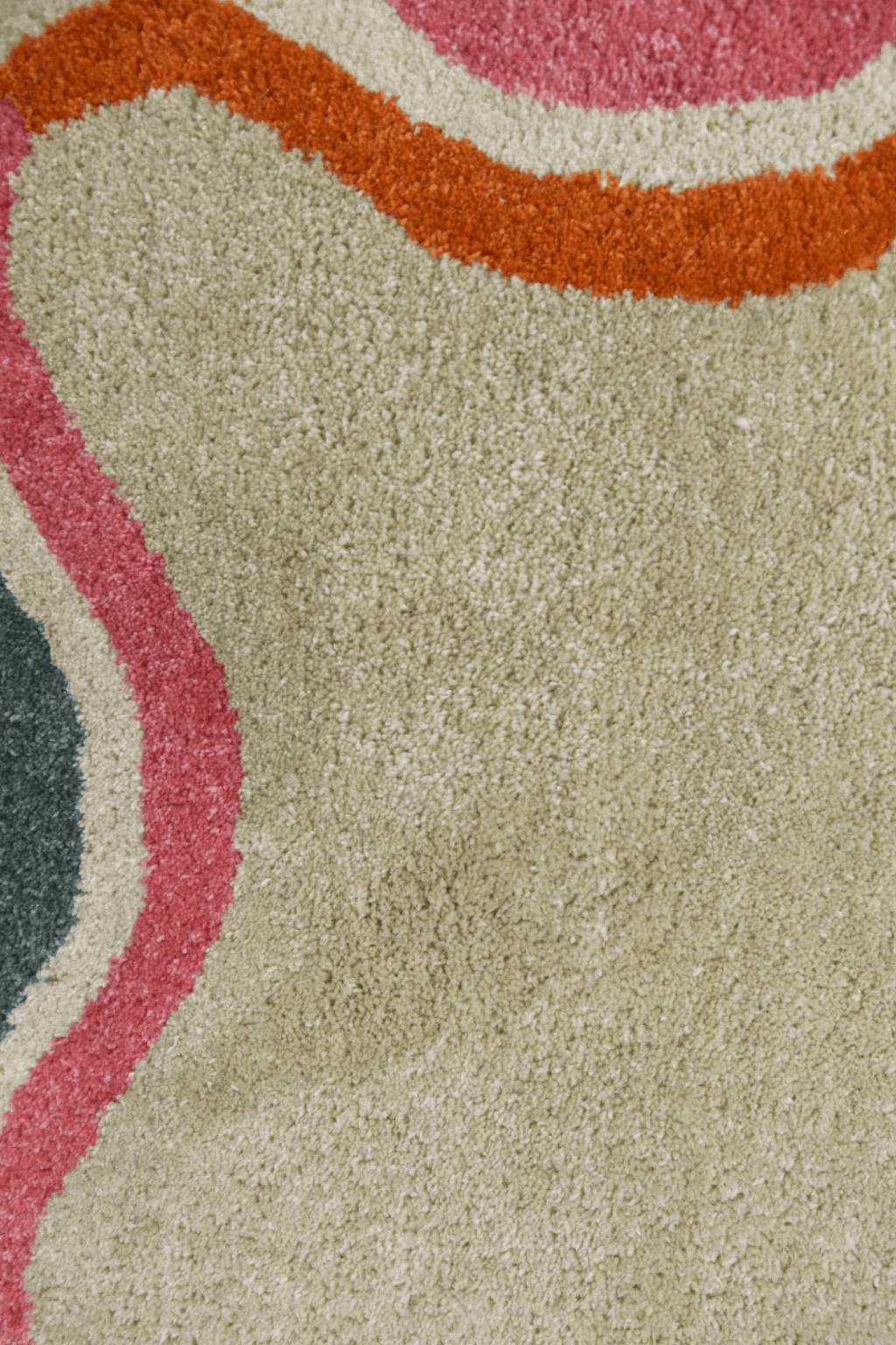 Scallop edge area rug featuring a soft ivory base with multicolor wave border patterns in pink, olive, rust, and blue.