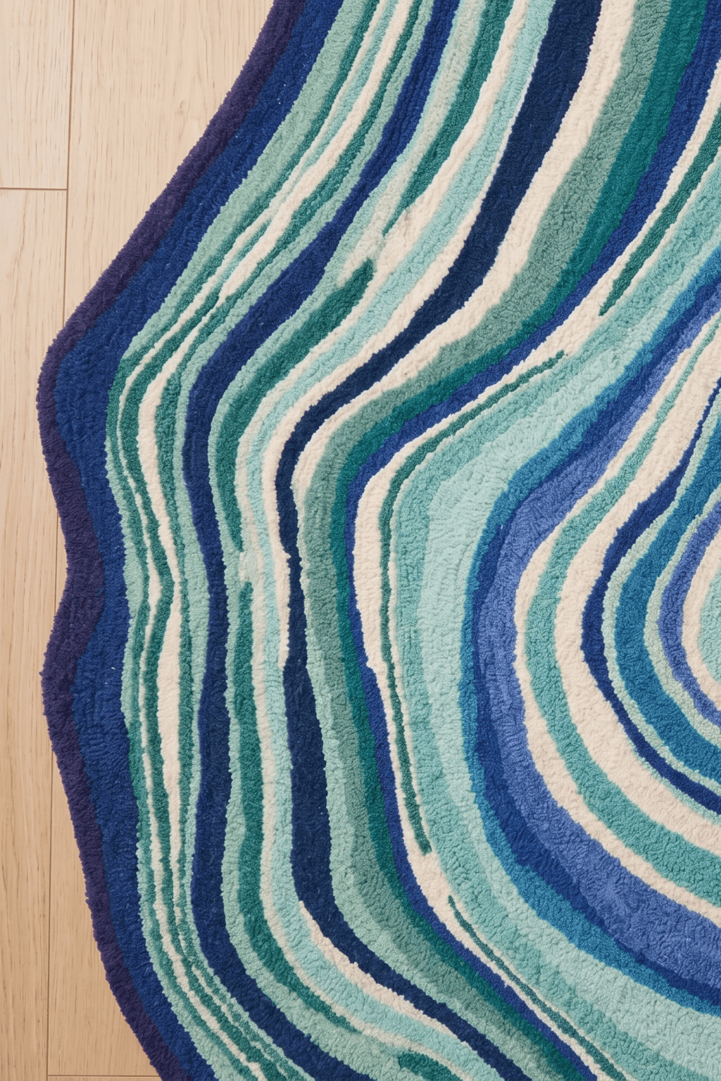 Azure stratum rug design featuring flowing waves of blues and greens representing natural formations.