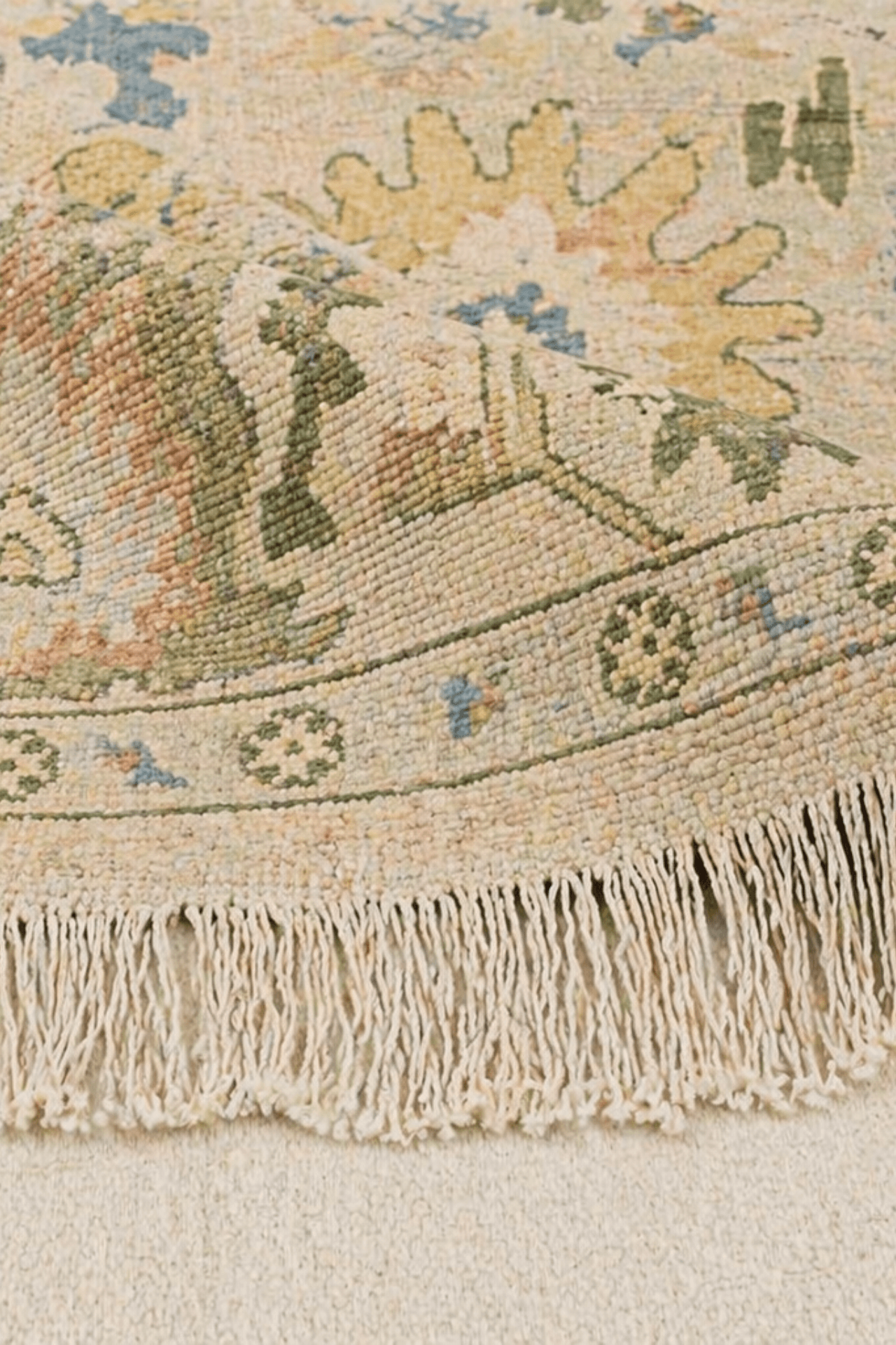 close-up of the Heritage Meadow Hand-Knotted Rug showcasing floral motifs and detailed fringes