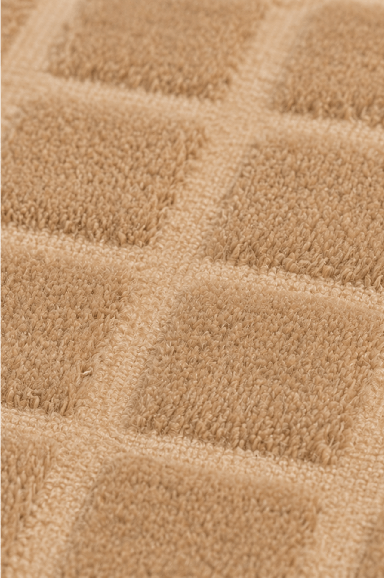 Close-up of the Terra Grid handloom grid rug showcasing its textured raised squares pattern.