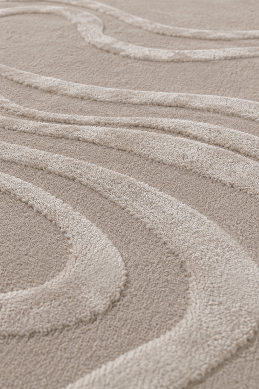 Close-up view of luxury hand-tufted flow rug showcasing its sculptural lines and soft ivory-beige texture.