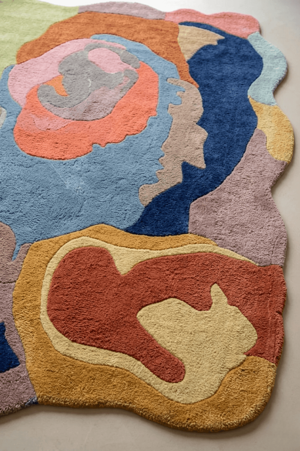 Terra Flow Abstract Hand-Tufted Rug showcasing colorful, earthy tones and an artistic, irregular silhouette.
