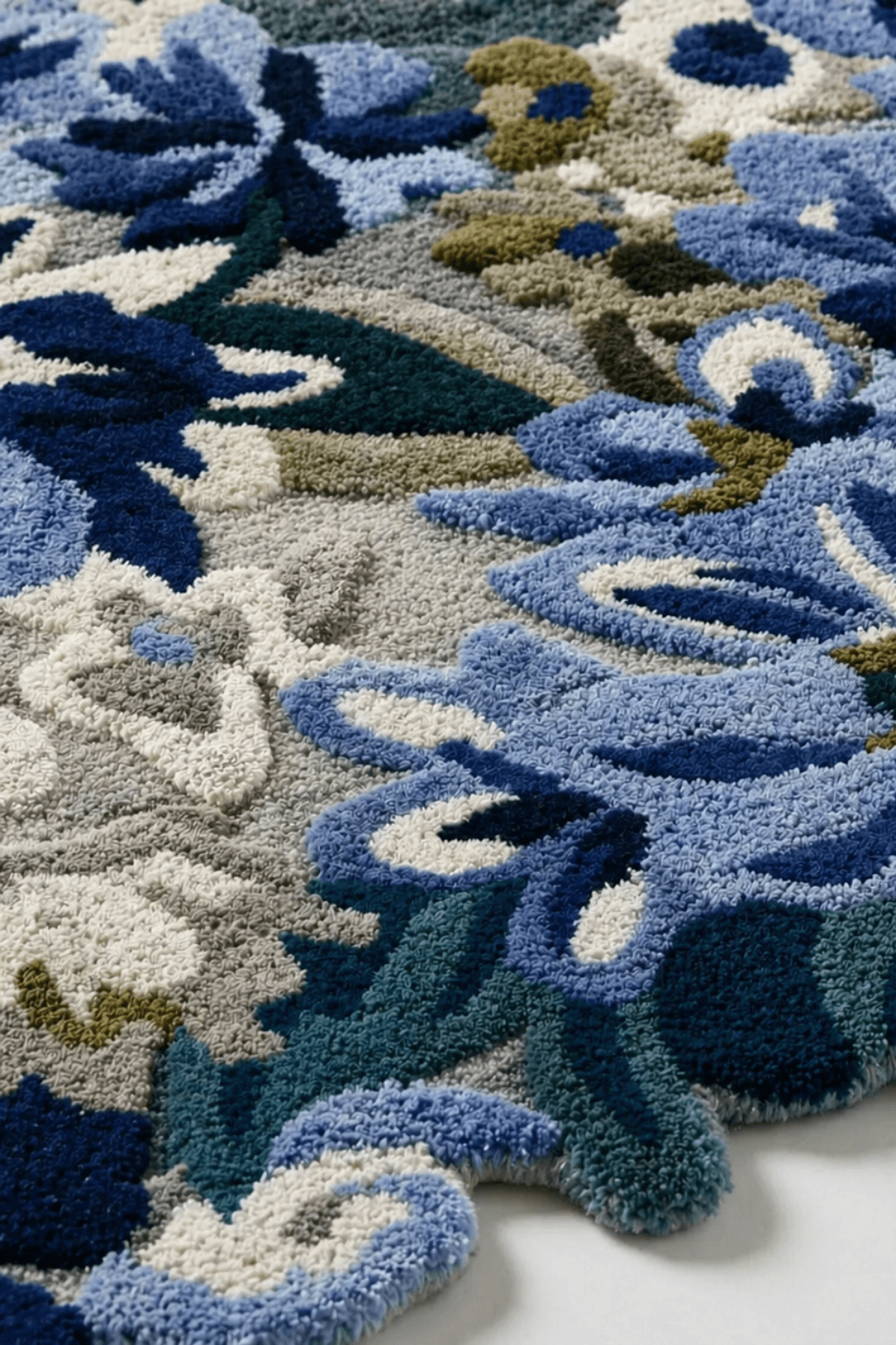 Hand-tufted floral area rug featuring delicate blue and ivory floral motifs, perfect for enhancing home decor.