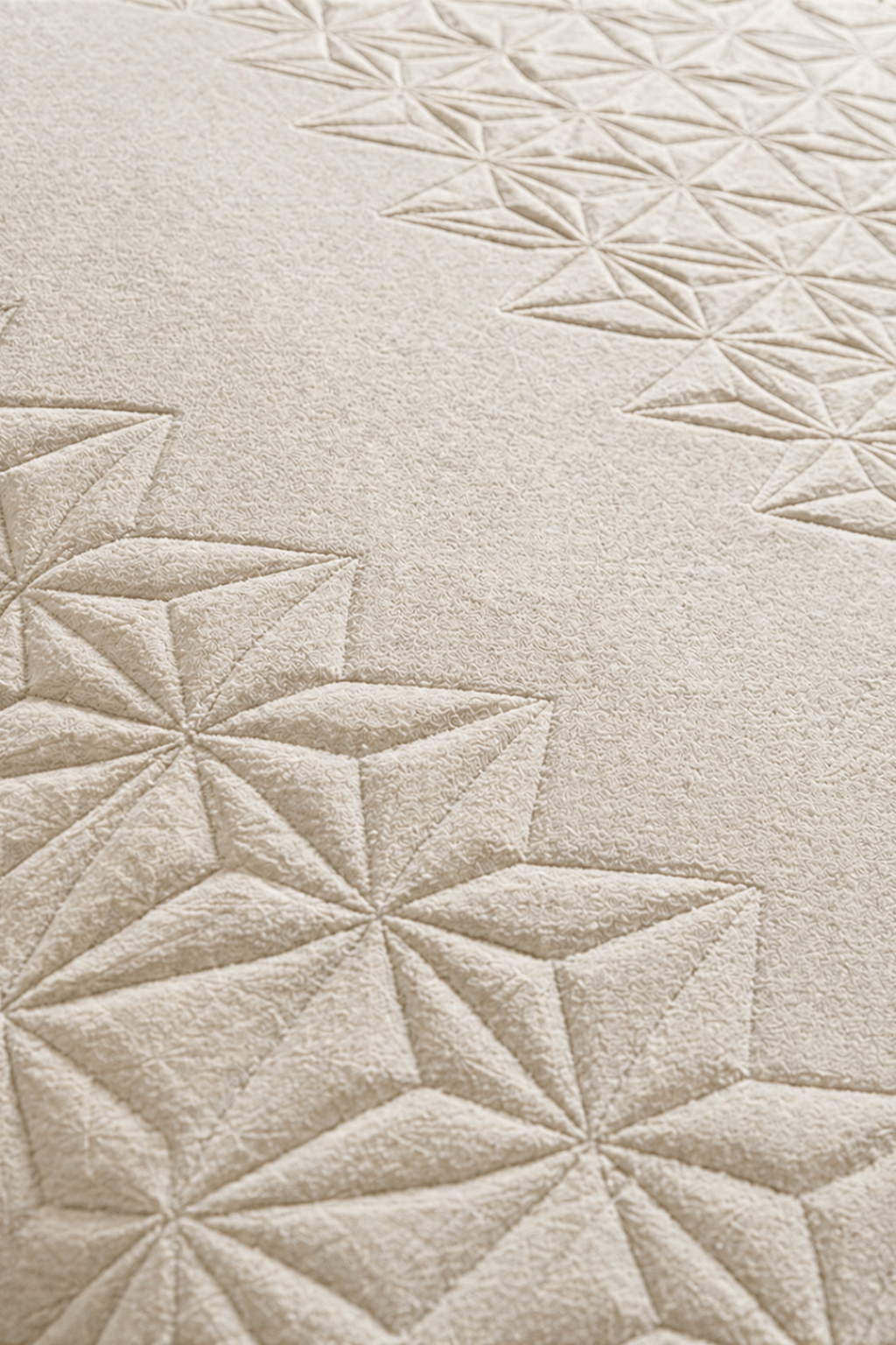 ivory geometric wool rug showcasing faceted star-like geometric motifs in a sculpted high-low pile.