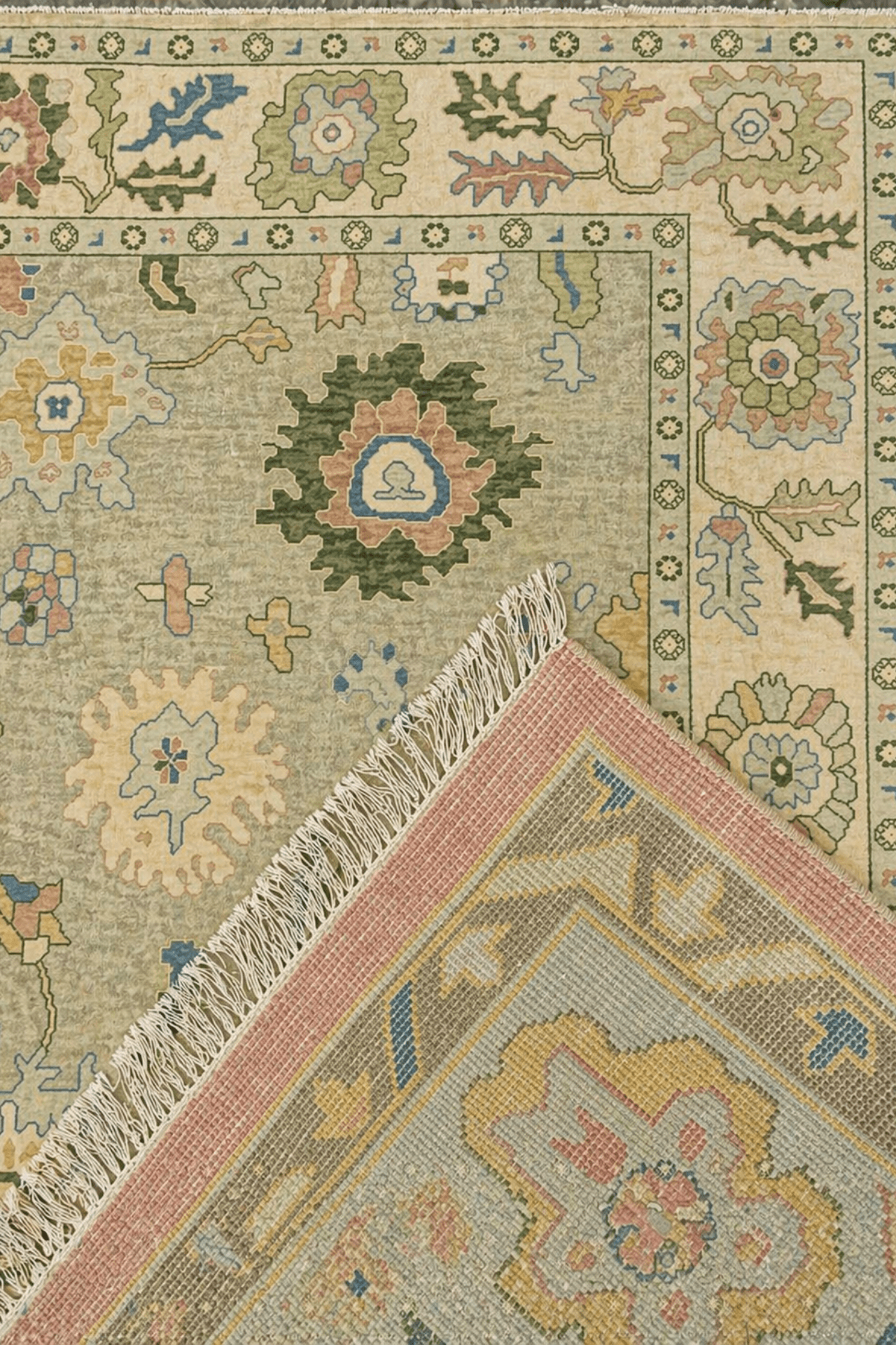 Hand-knotted heritage meadow rug showcasing floral motifs and intricate design on a sage-green field.