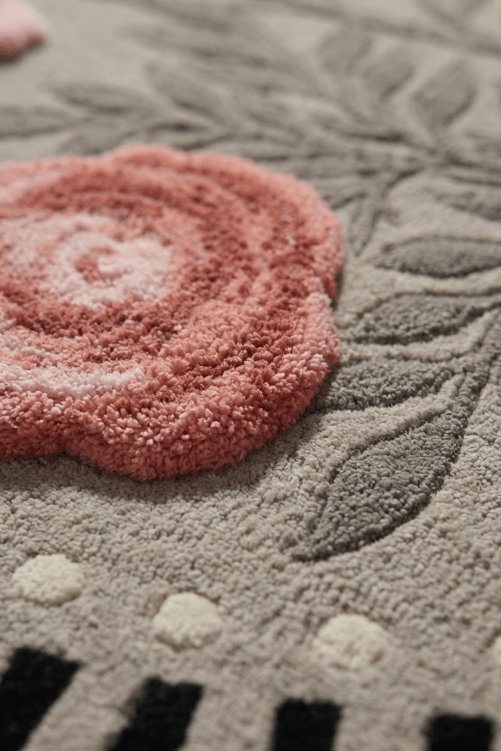 Close-up of botanical irregular sculptural rug featuring textured floral designs in soft colors.