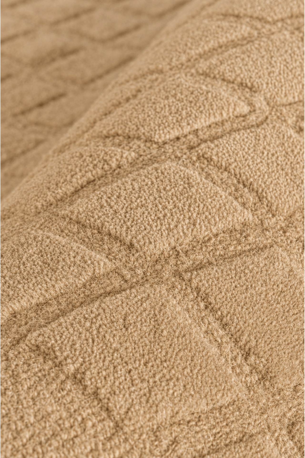 Close-up of the Terra Grid handloom grid rug showcasing its unique textured pattern and warm color.