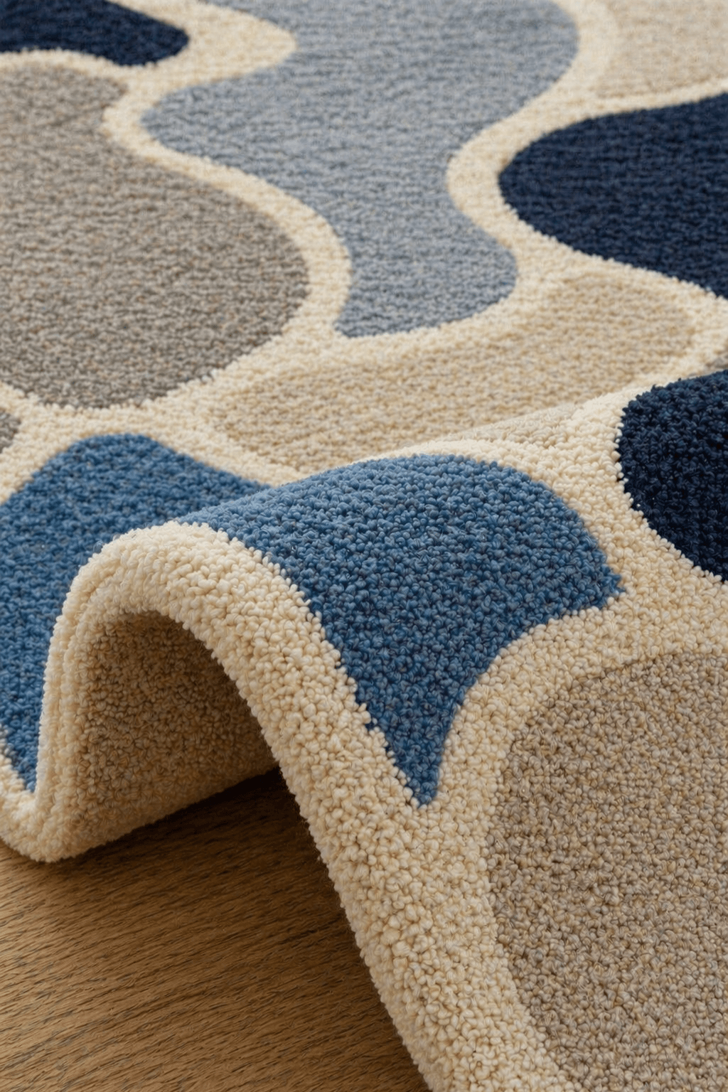 Close-up of Azure Hive geometric abstract hand tufted rug showcasing textured patterns in blue and neutral tones.