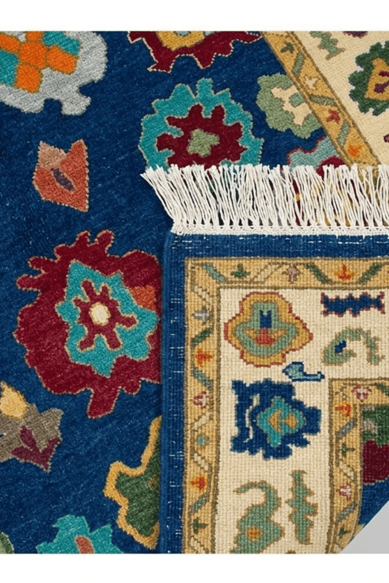 deep blue hand-knotted wool rug showcasing artisan motifs and detailed fringe.