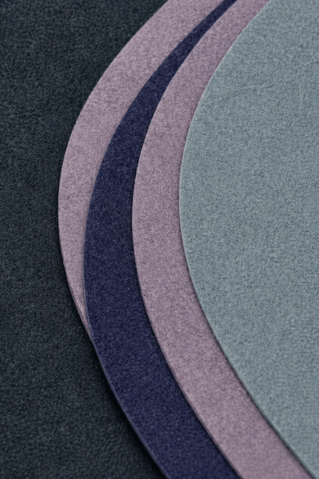 Midnight flow sculpted rug showcasing deep charcoal, slate blue, and soft lavender hues in a contemporary design.