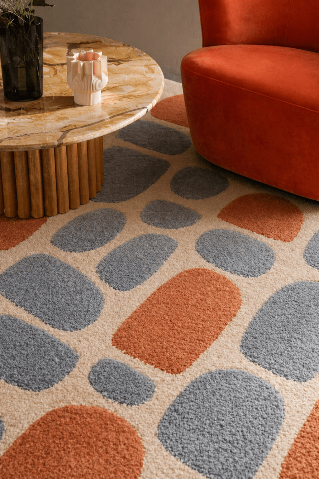 Pebble Harmony Hand-Tufted Wool Area Rug featuring abstract stone shapes in slate blue and terracotta.