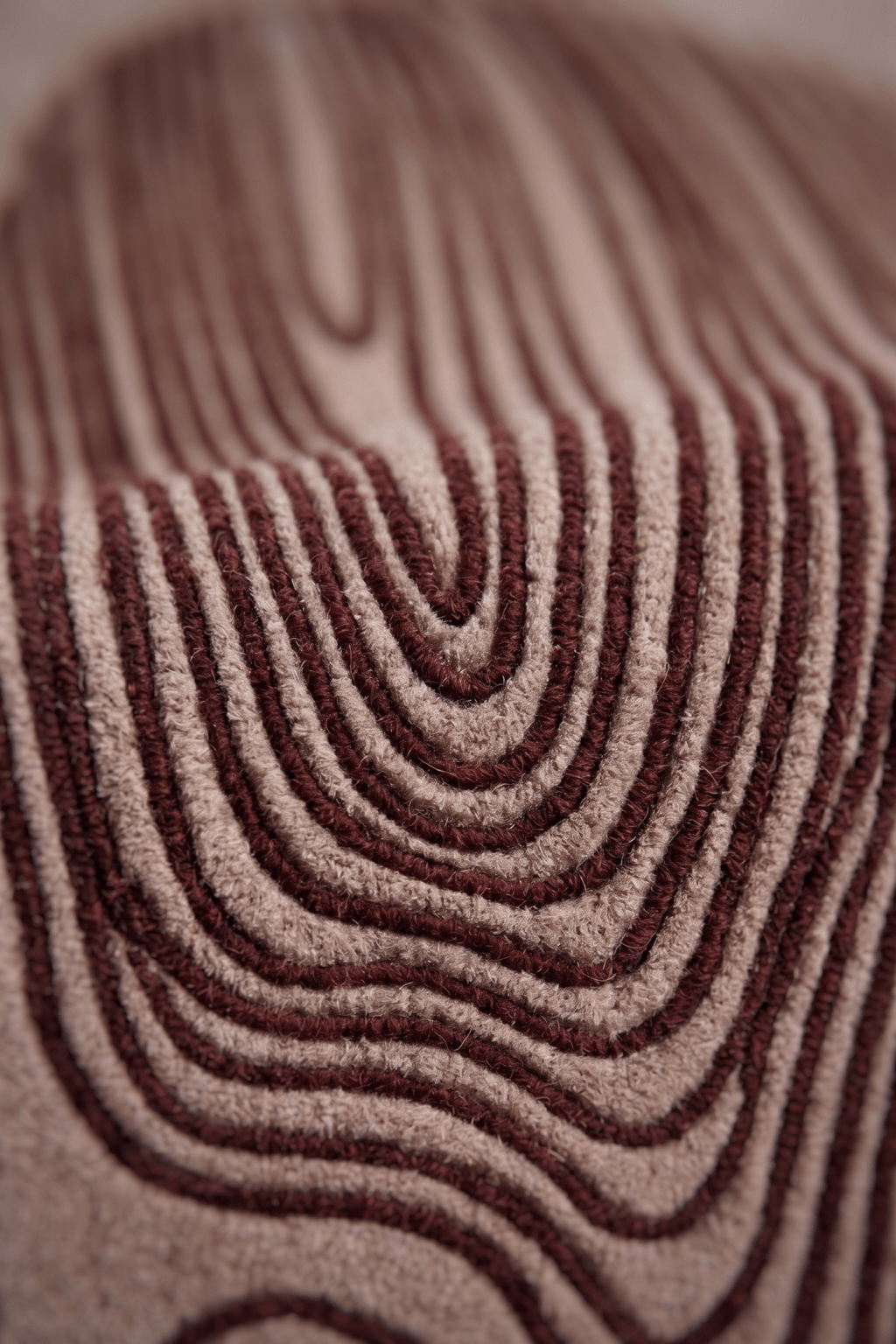 Close-up of the Crimson Contour Irregular Rug showcasing deep burgundy linework on a neutral background, an irregular area rug.