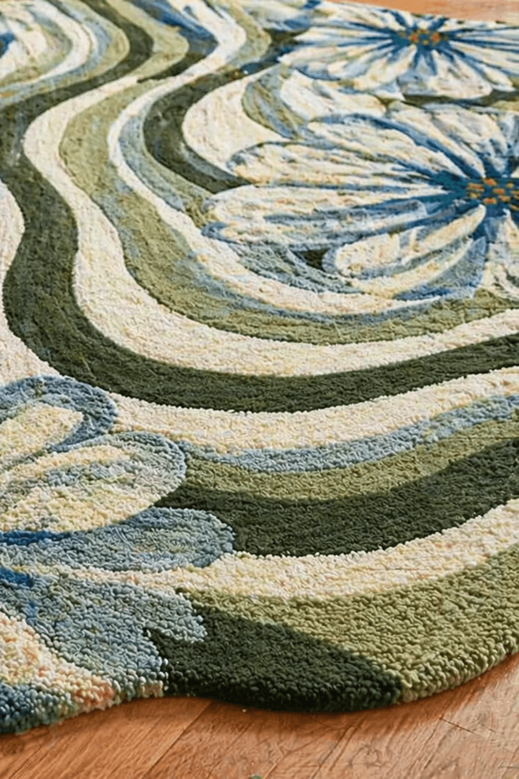 Modern floral area rug featuring flowing wave-like designs in rich greens and soft ivory.