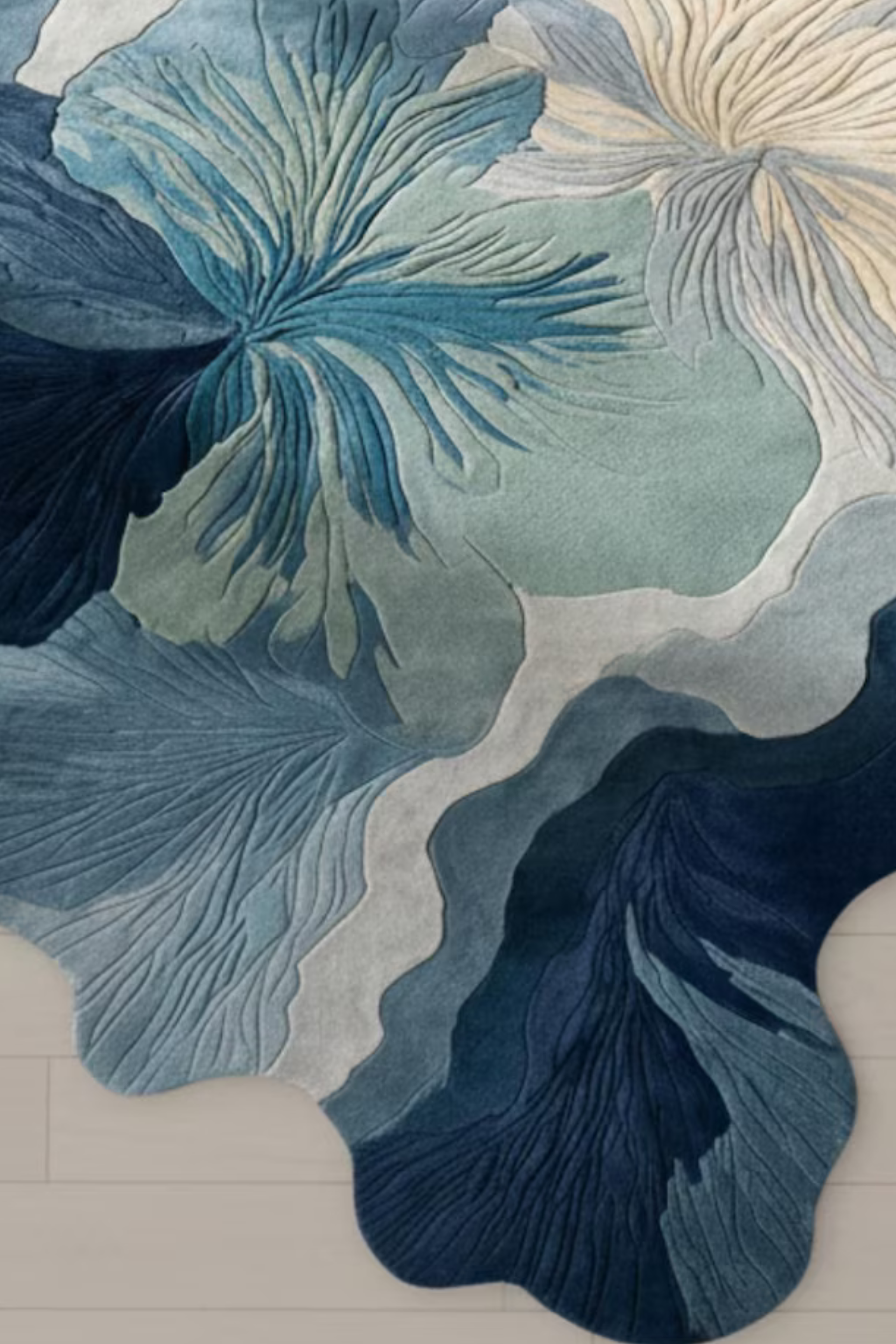Ivora Lines hand-tufted rug featuring abstract floral patterns in shades of blue, green, and cream on a light wood floor.