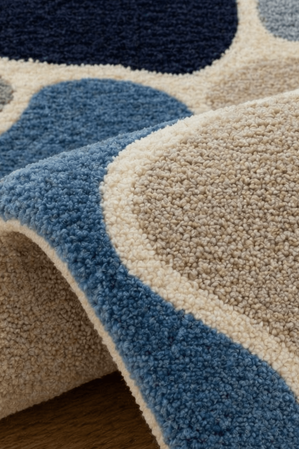 Close-up of the Azure Hive geometric abstract hand tufted rug showcasing soft grey, navy, and steel blue colors.