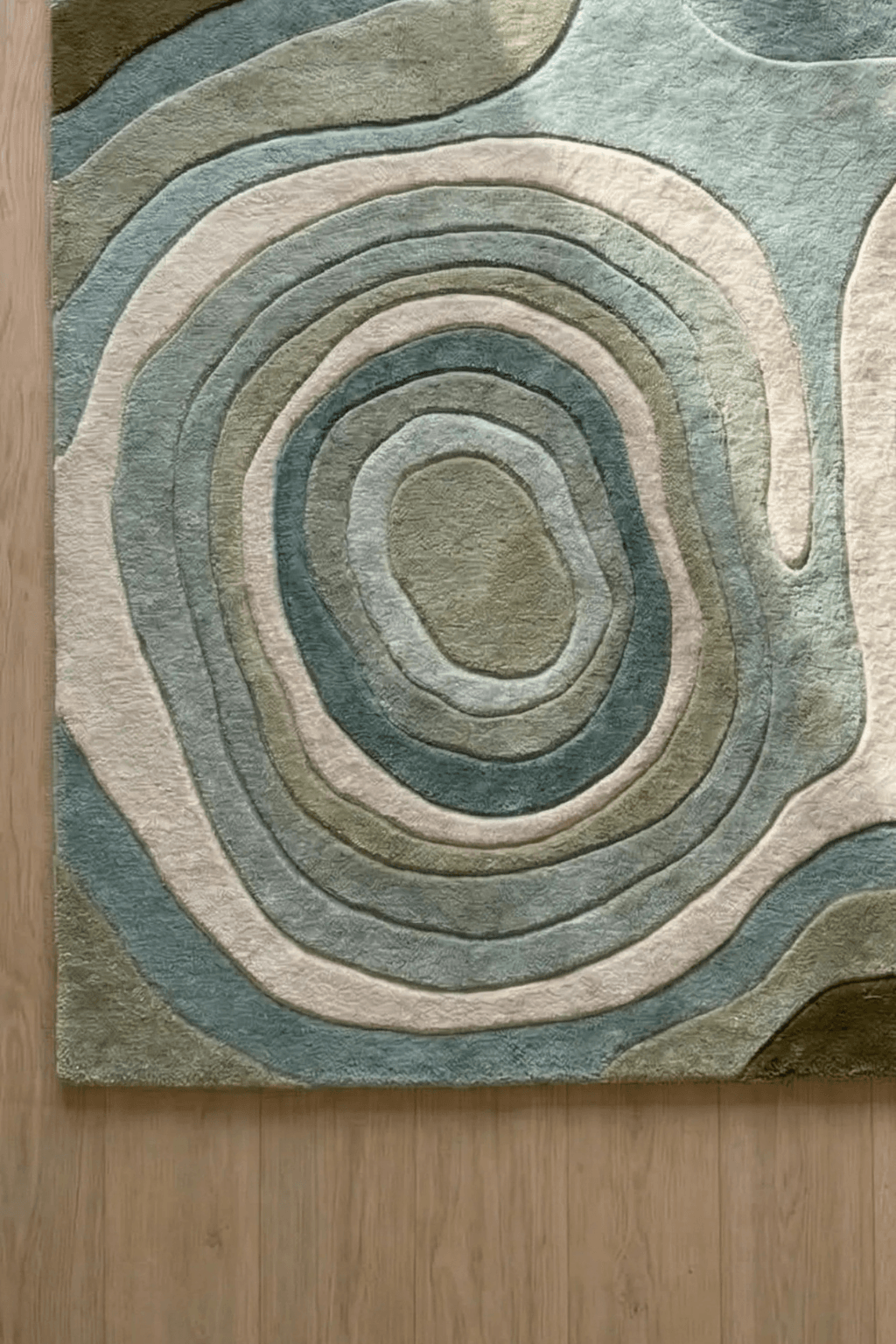 Nature-inspired contour rug with fluid organic shapes in soft sage, olive, and ivory tones.