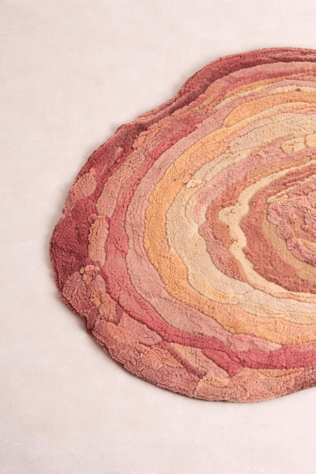 Blush Terrain Organic Rug with layered contours in blush, coral, peach, and beige shades for an artistic touch.