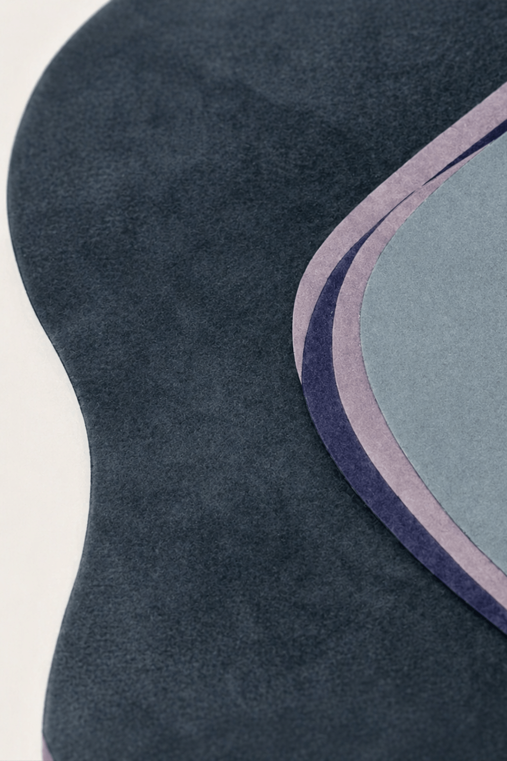 Midnight flow sculpted rug showcasing deep charcoal, slate blue, and soft lavender contours in a contemporary design.