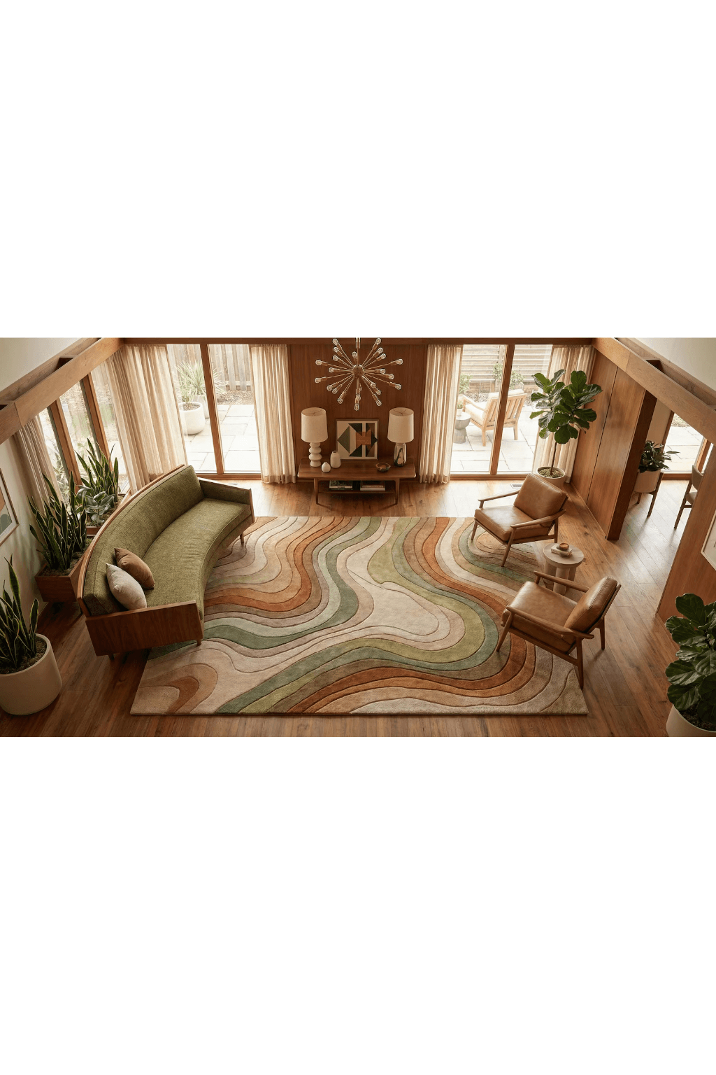 Top view of a living room featuring a Sand Dune Contour Scallop Rug placed under a green sofa and wooden chairs.