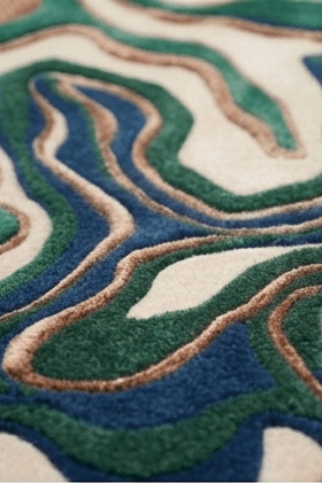 Close-up of the Terra Wave Contour Rug showcasing its layered, topographic design with earthy tones.
