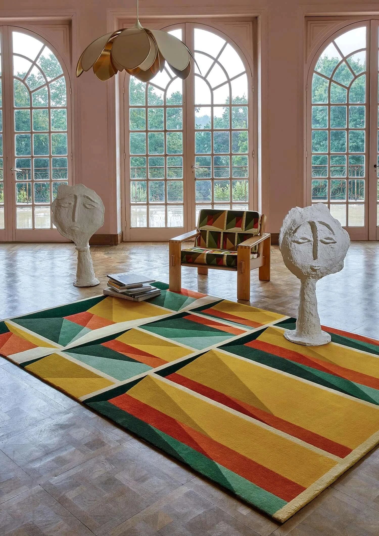 Facet Mirage Hand-Tufted Rug in a modern living room with geometric patterns and vibrant colors.