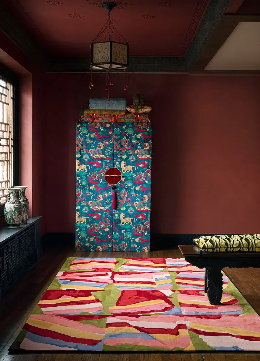 Saekdong Reverie hand-tufted rug with multicolored bands in a vibrant room featuring traditional motifs.
