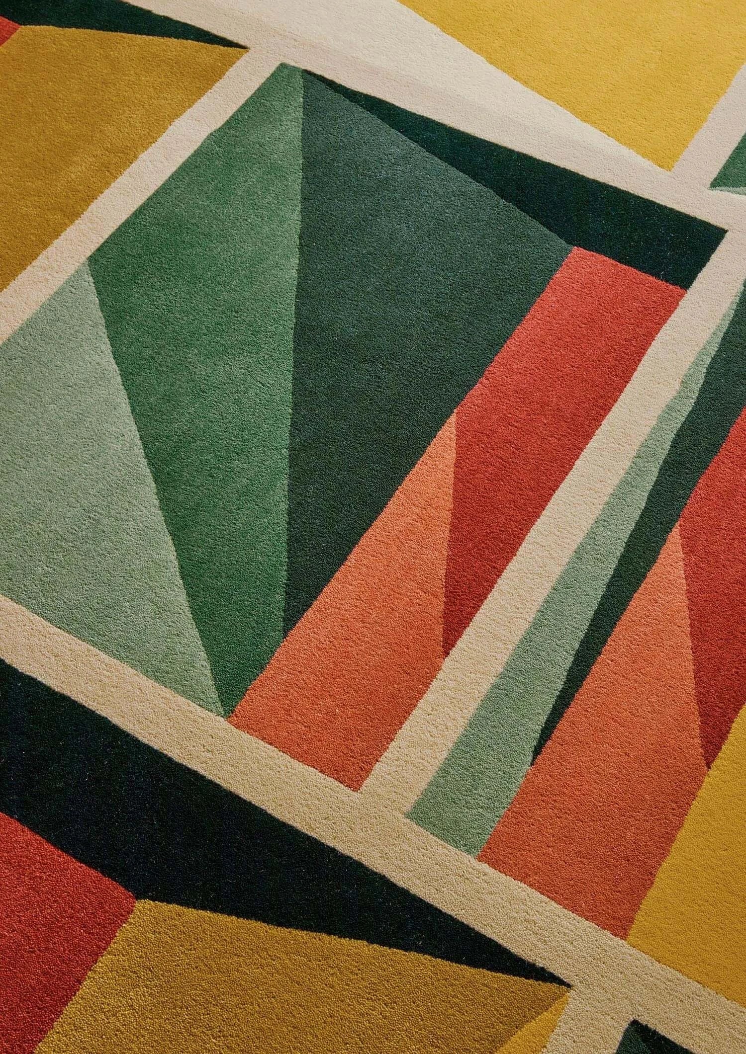 Close-up of the colorful geometric patterns on the Facet Mirage Hand-Tufted Rug, showcasing vibrant angles and textures.