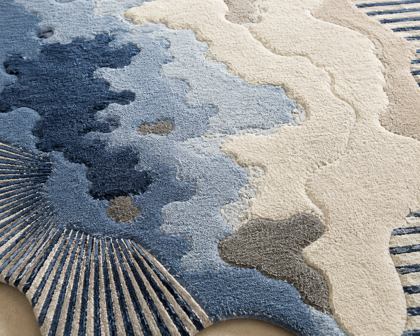 Aurelia Tides abstract rug featuring abstract textures in deep navy, misty blue, warm ivory, and soft taupe.