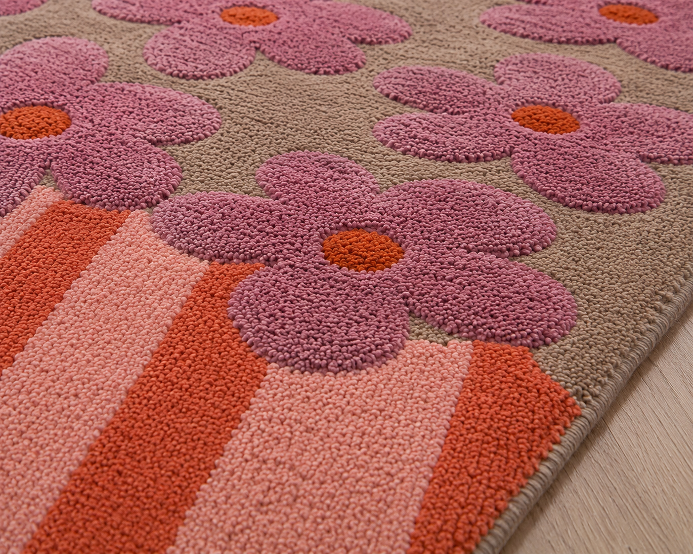 Artistic floral area rug featuring bold pink blossoms and soft painterly stripes in warm colors.