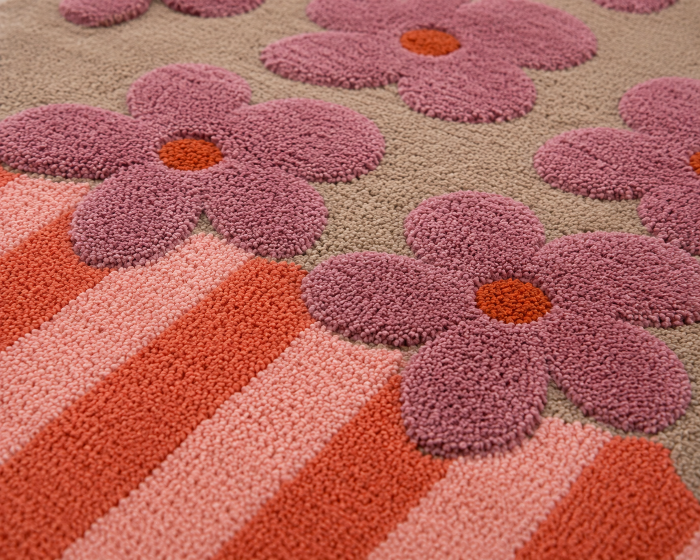 artistic floral area rug featuring bold hand-drawn blossoms and colorful painterly stripes.