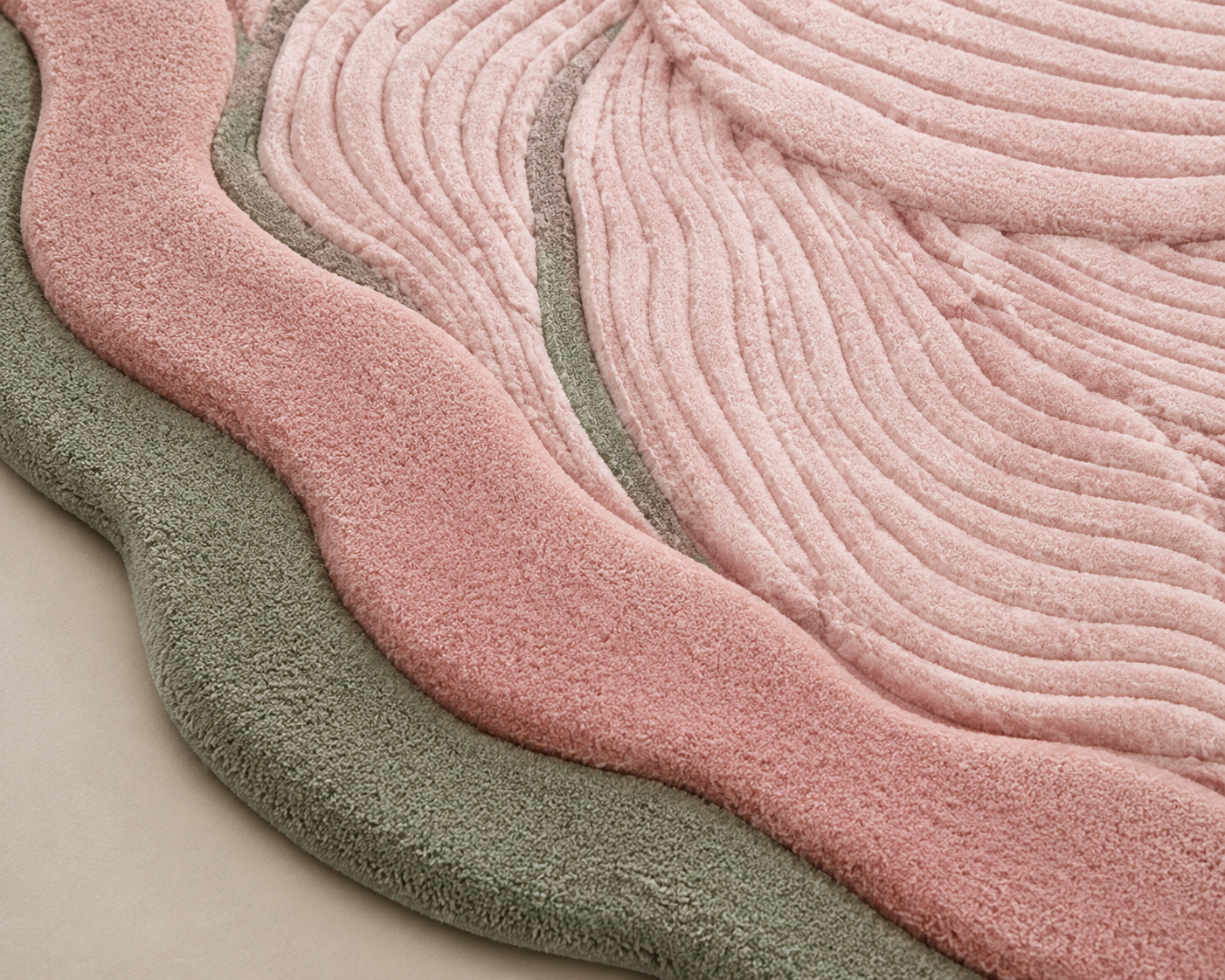 Close-up of the blush contour area rug showcasing soft pink and sage colors in fluid designs.