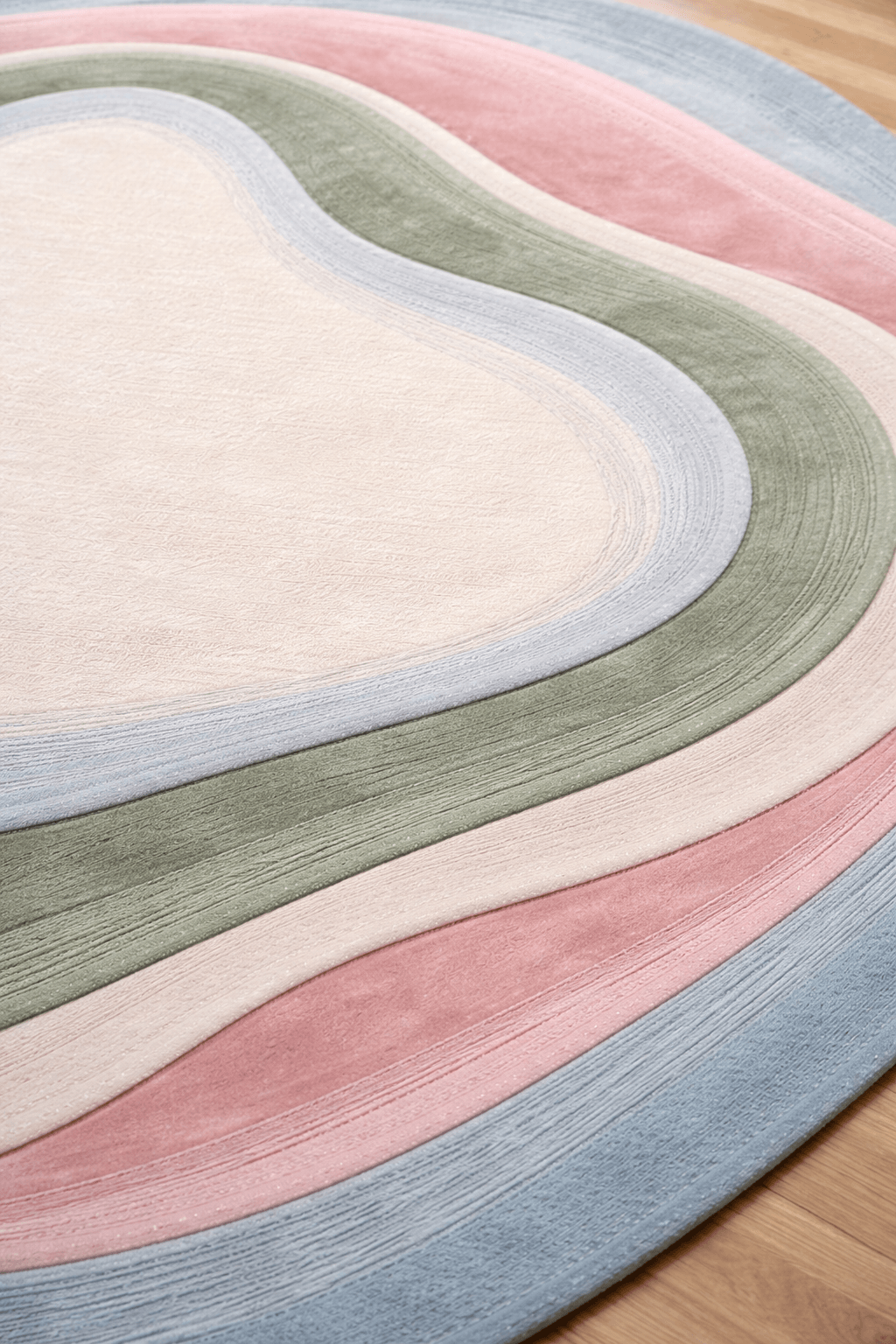 close-up of contemporary contour rug with soft pastel colors and organic shapes on wooden floor