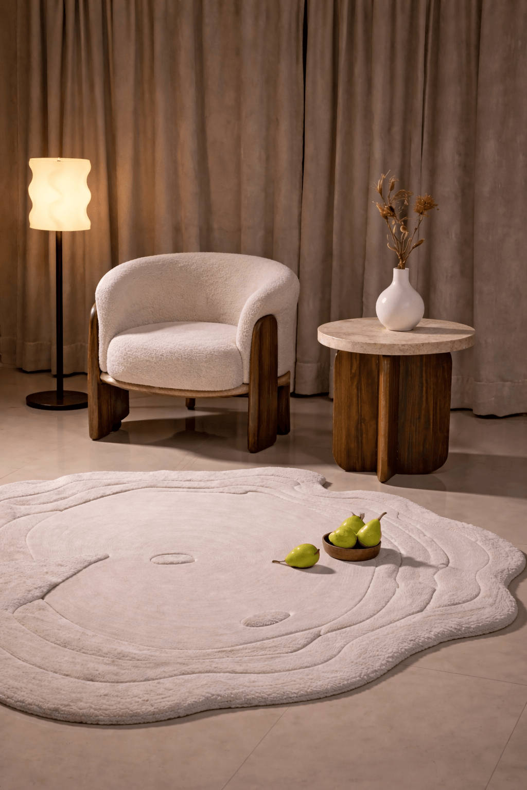 Crescent Calm rug in a modern living space with a cozy chair and table, showcasing its elegant organic shape.