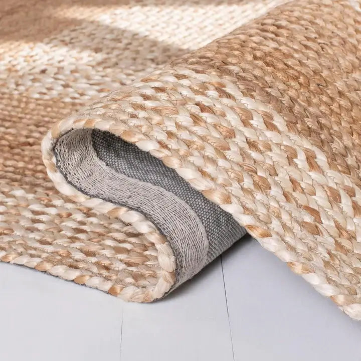 Close-up of an Ivory Fade Braided Jute Rug showcasing its braided flatweave texture and natural color gradient.