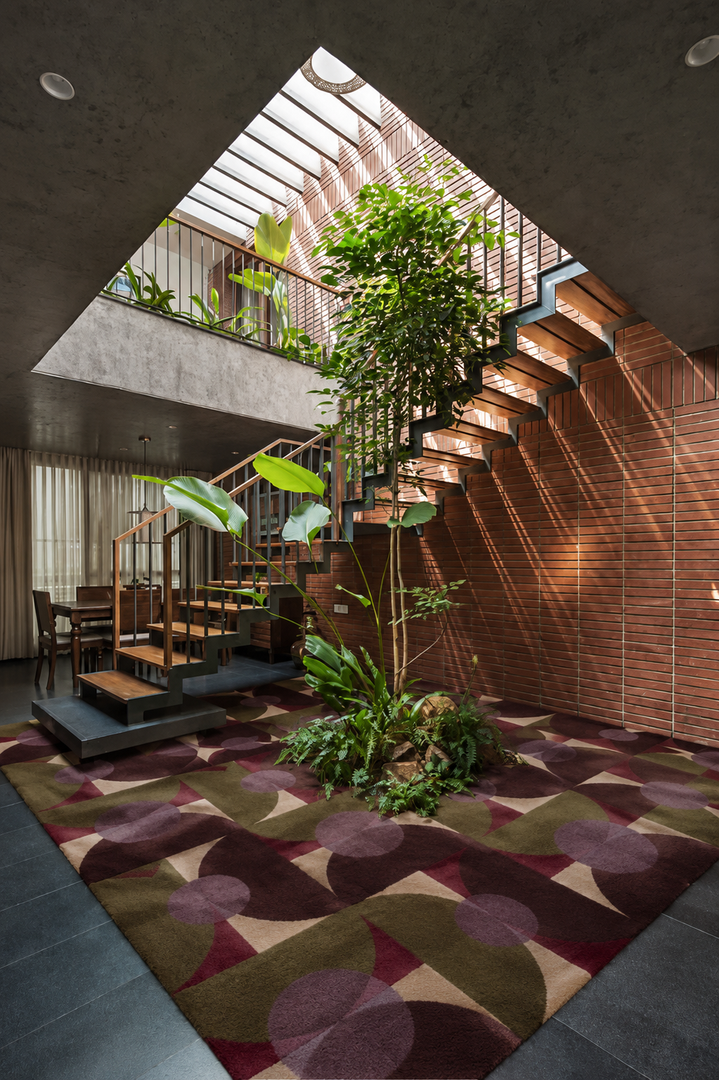 Stylish interior featuring the Luna Mosaic Area Rug surrounded by modern architecture and lush greenery.