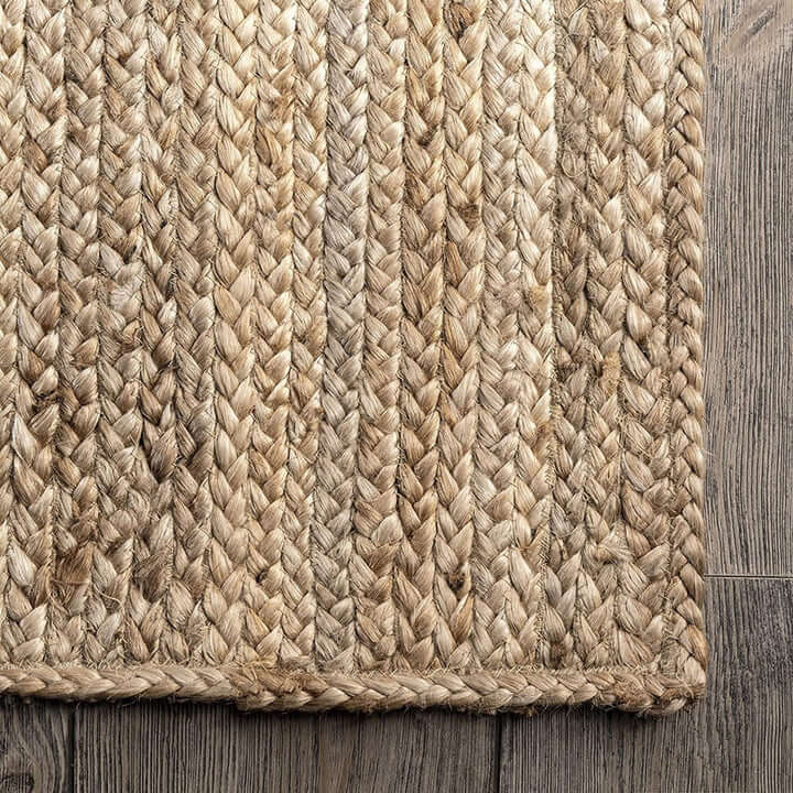 Natural braided jute rug showcasing a textured flatweave design with a structured border.
