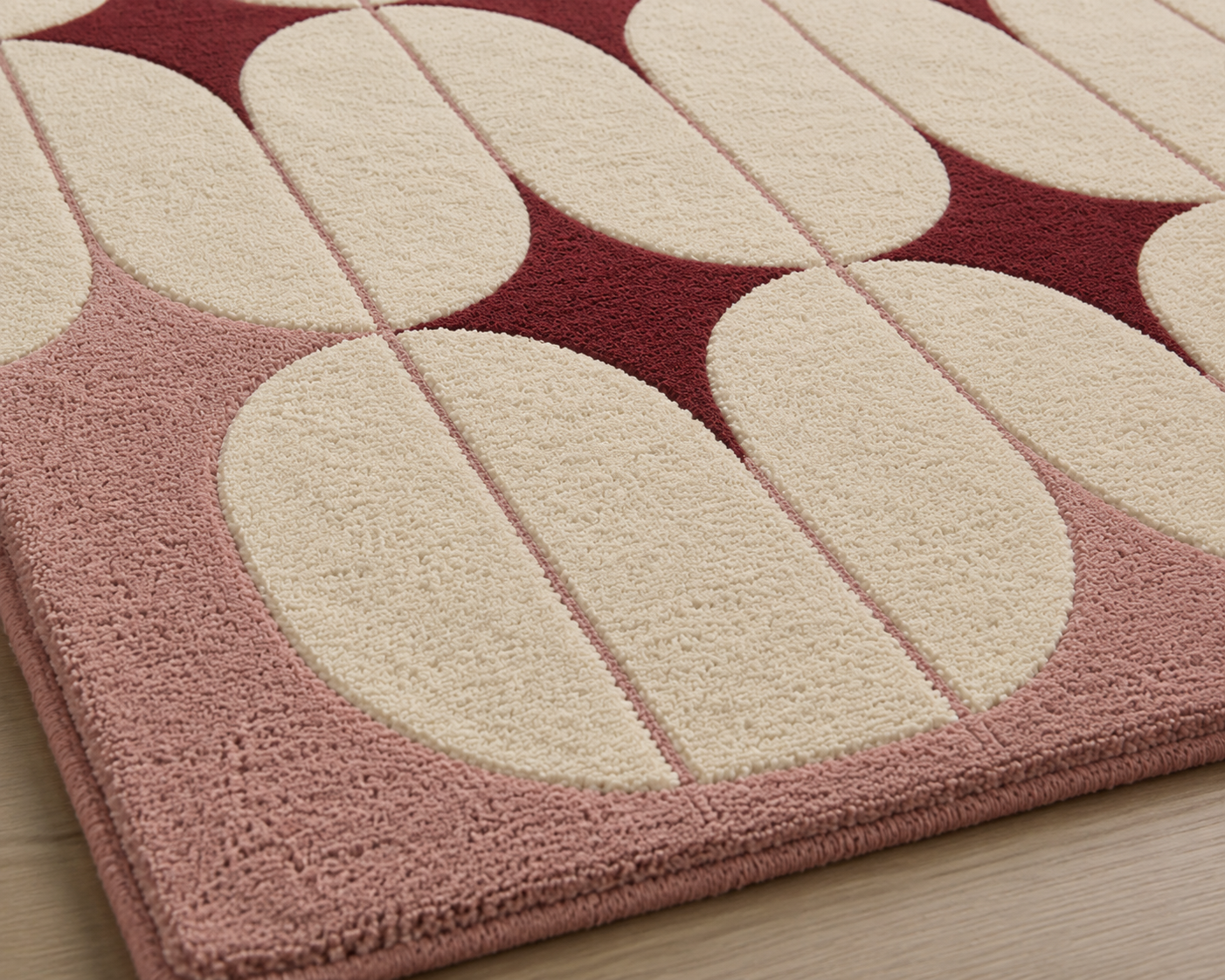 Close-up of the Retro Blush Geometry Rug showcasing its blush geometric area rug design with ivory ovals and burgundy motifs.