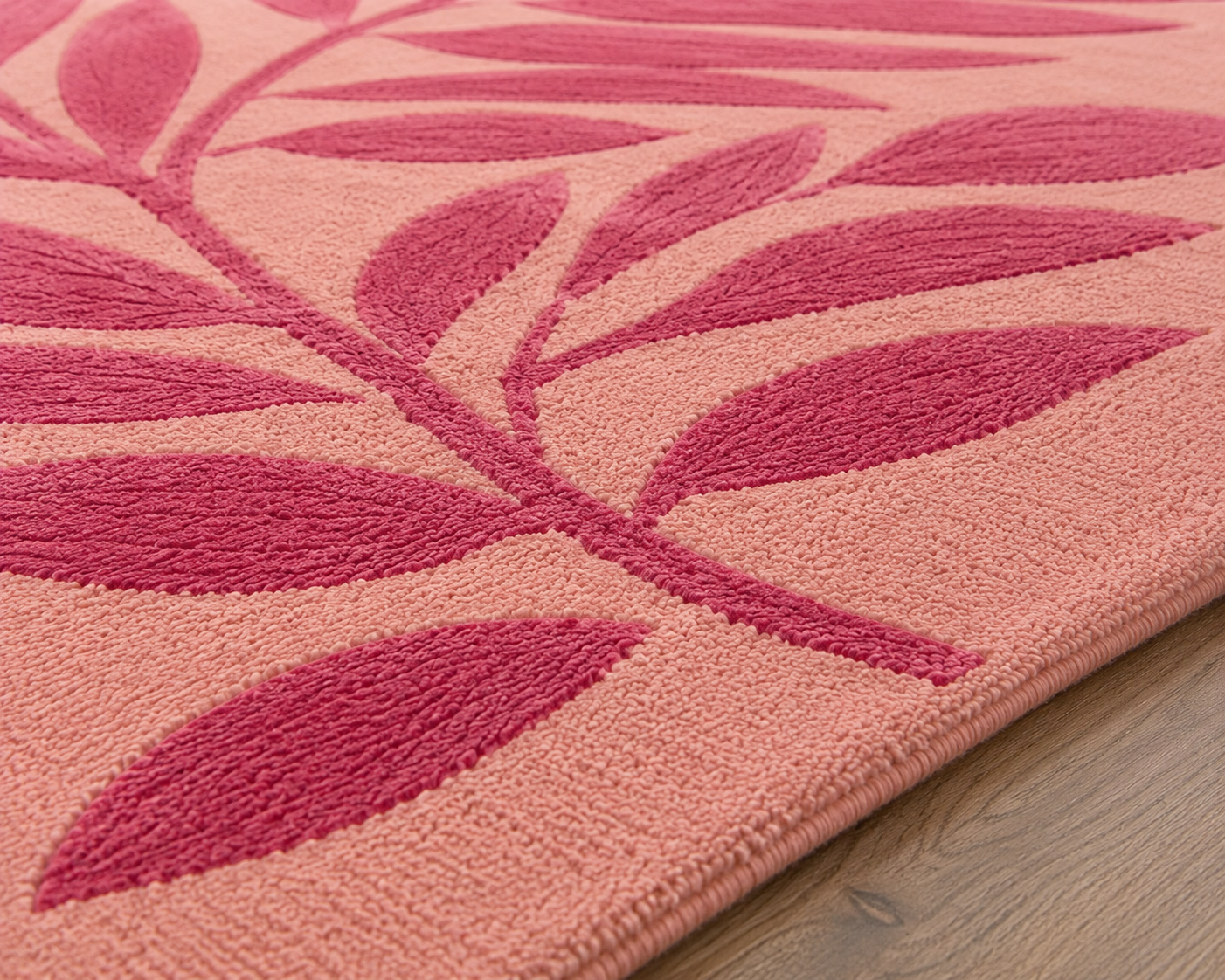 Close-up of the Roselle Canopy Rug featuring a botanical design canopy rug with pink leafy patterns on a blush background.