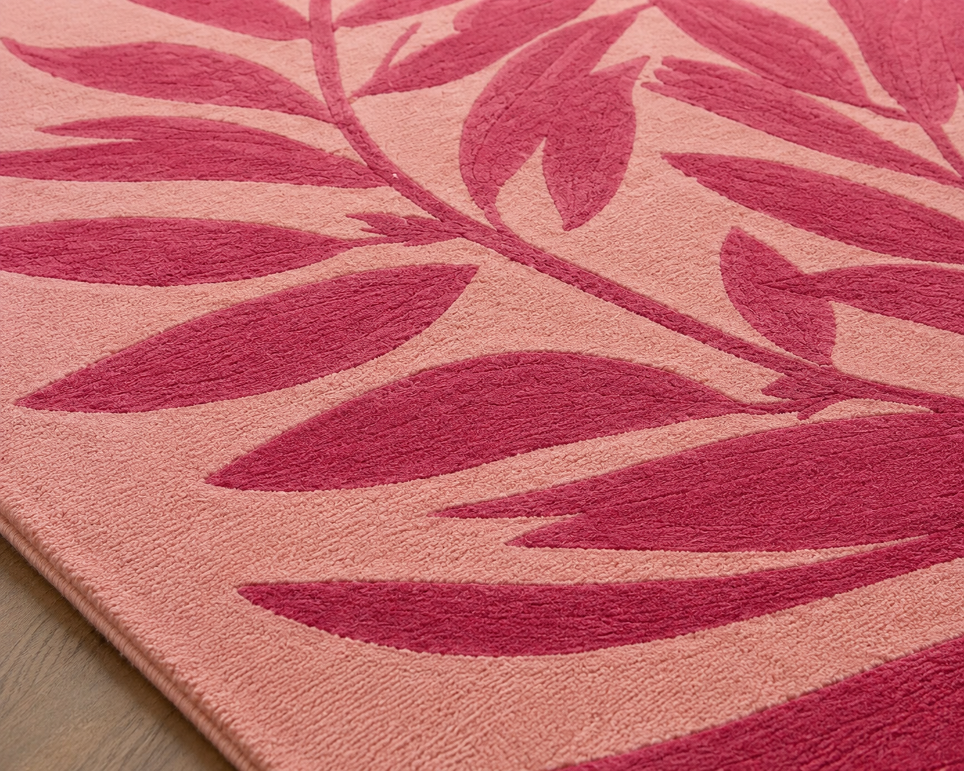 Close-up of the Roselle Canopy Rug featuring a botanical design canopy rug with blush background and rich berry leaves.