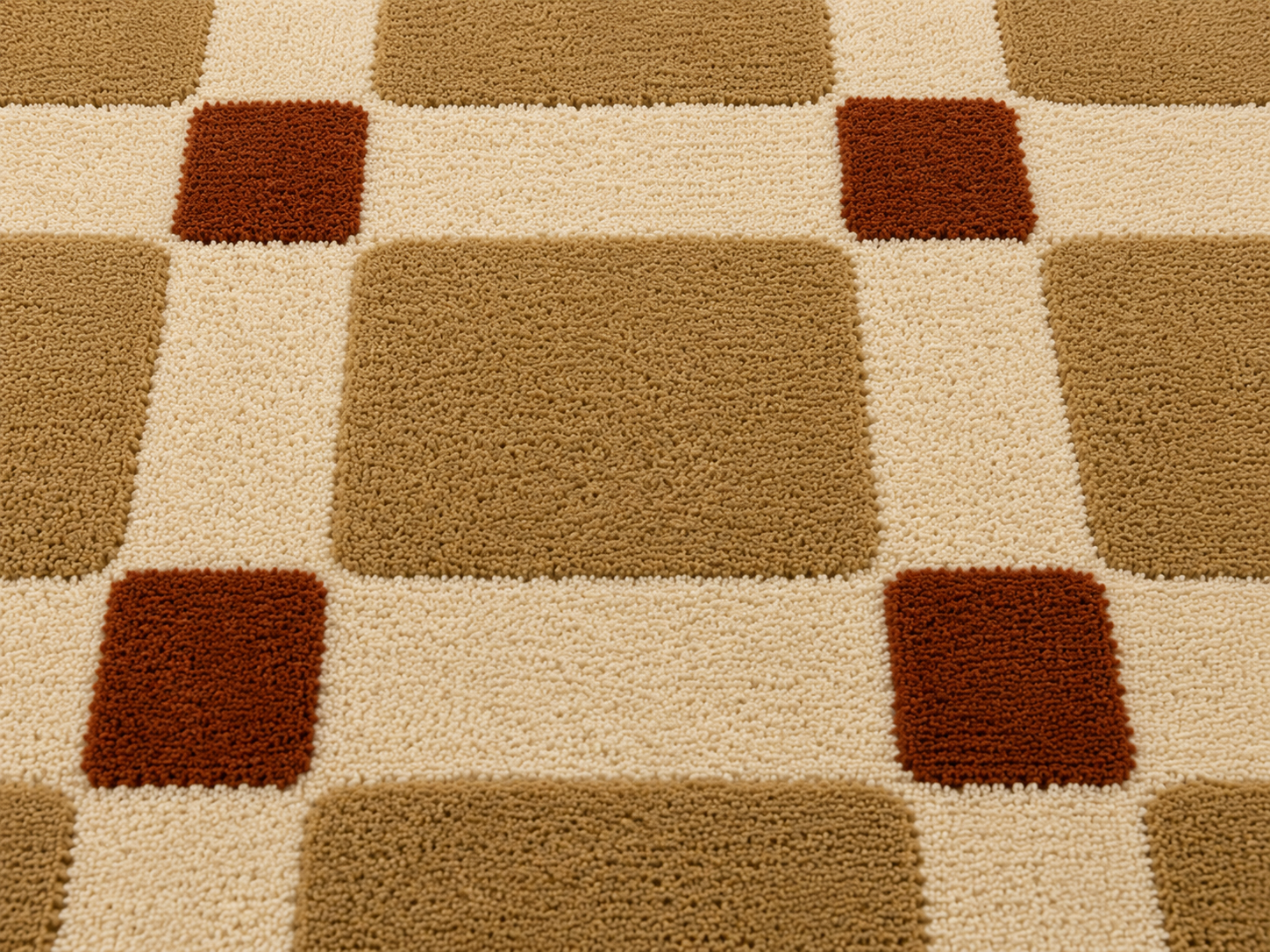 Close-up of the terra grid harmony rug featuring a soft ivory base with rounded camel squares and terracotta accents.
